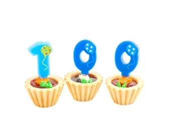 cakes with one hundred years birthday candles on white