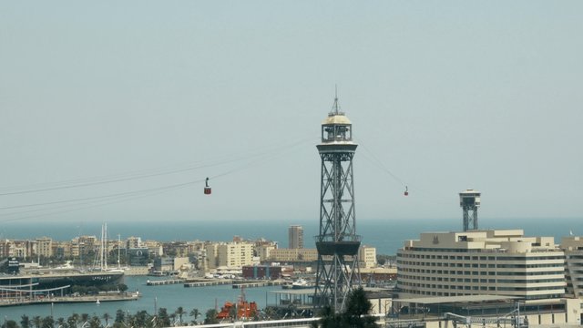 Aerial tramway tower and Port Vell in Barcelona