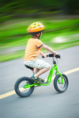 Naklejka premium Little boy riding a bicycle