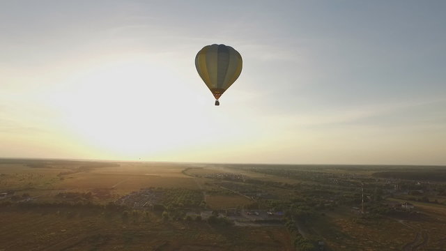 Flying a balloon at sunset