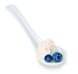 Spoon of blueberry yogurt isolated on white