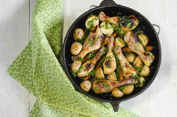 Crisp-tender chicken baked with roasted carrots and potatoes, above view