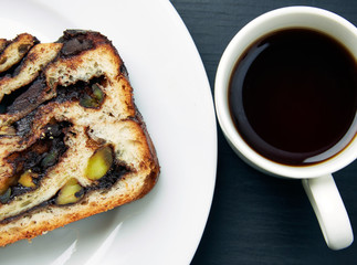 Slice of Bread Cake and a Cup of Tea on Table