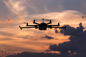 Professional drone flying in the sunset