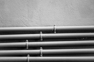 Industrial pipes with wall background