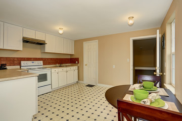 Very simple kitchen with tile floor.