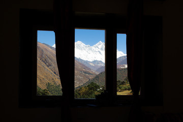 Everest snow peak view through hotel resort room window.