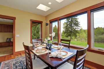 Simple dinning room with large windows.