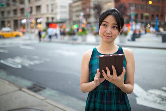 Young Asian woman using tablet computer