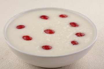 Homemade rice porridge with red plums and honey.Healthy breakfast.