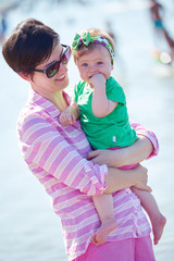 mom and baby on beach  have fun