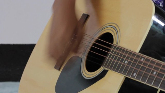 close-up of man playing guitar