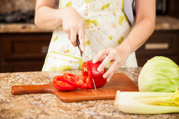 Woman cutting some red peppers