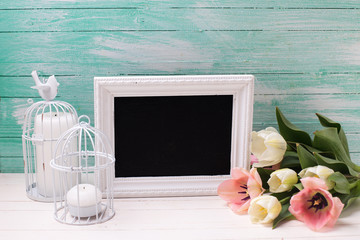 Background with flowers, empty blackboard and candles