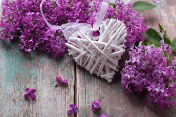 Background with decorative heart and fresh lilac flowers