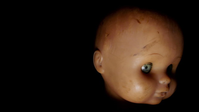 Scary doll. Close-up of doll, turning forward.
