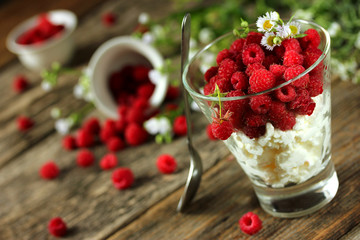 Fresh cottage cheese with raspberries in a glass
