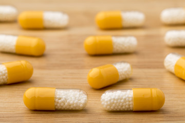 Close up medical capsules on wooden table