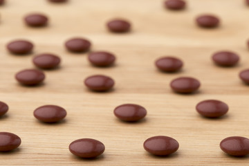 Close up brown pills on wooden table background