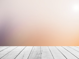 White wood floor with blurred sunlight sky background