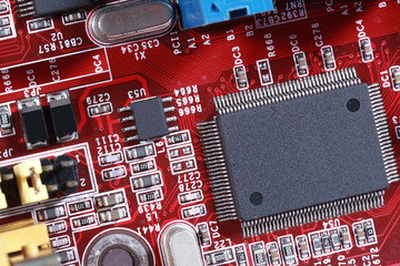 Close-up of electronic circuit red board with processor