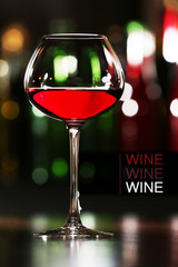 Glass of red wine in bar on blurred background