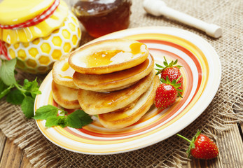 Homemade pancake with honey and strawberry