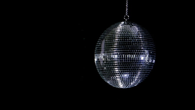 Disco ball with reflected moving rays. Anamorphic lens fare.

