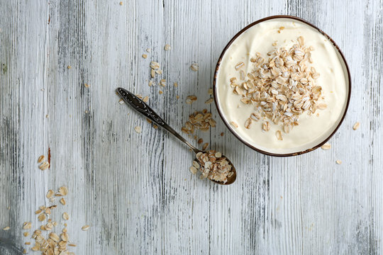 Healthy homemade oatmeal on wooden table, close up