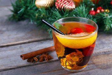 Sangria in bowl and glass with Christmas decoration on wooden table close up