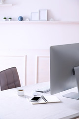 Workplace with computer in room