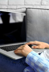 Woman using laptop, indoors