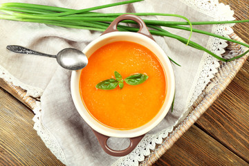 Carrot cream-soup with vegetables on table close up