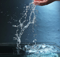 Water splashing on blue background