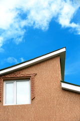 Roof of house on blue sky background