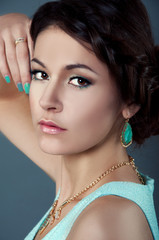 Studio portrait of beautiful brunette in teal dress