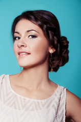 Studio portrait of beautiful brunette in teal dress