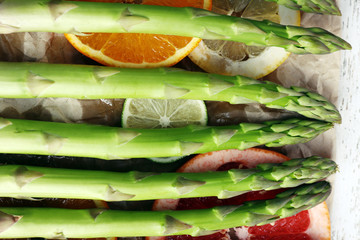 Fresh asparagus on wooden tray, close-up