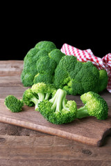 Fresh broccoli on wooden table close up