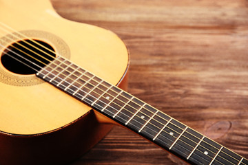 Obraz na płótnie Canvas Acoustic guitar on wooden background