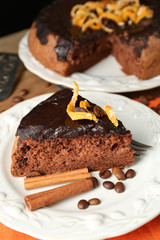 Cake with Chocolate Glaze and orange on plate, on wooden background