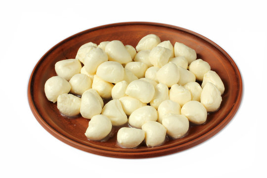 Mozzarella mini balls in a bowl isolated on white background