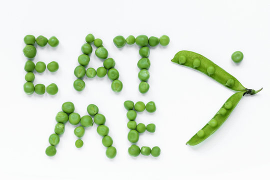 Eat me: inscription green peas isolated on a white background