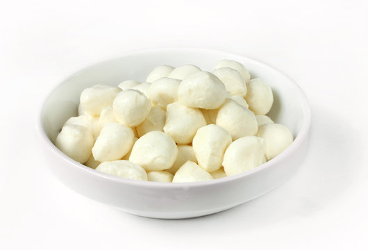 Mini mozzarella in a white bowl on a white background