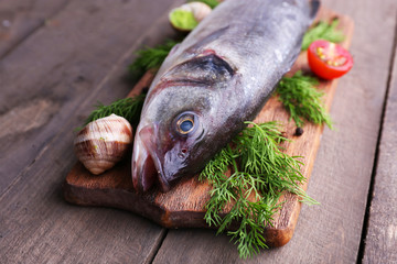 Zander fish and other ingredients on wooden table, closeup