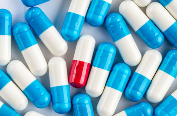 blue capsules and red capsules, medication cure close up