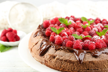 Cake with Chocolate Glaze and raspberries on color wooden background