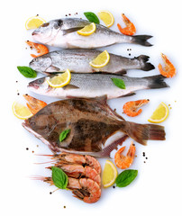 Fresh fishes and shrimps with spices  isolated on white