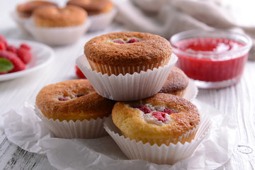 Delicious cupcakes with berries on table close up