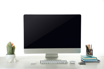 Fototapeta premium Computer on wooden table with blank white background